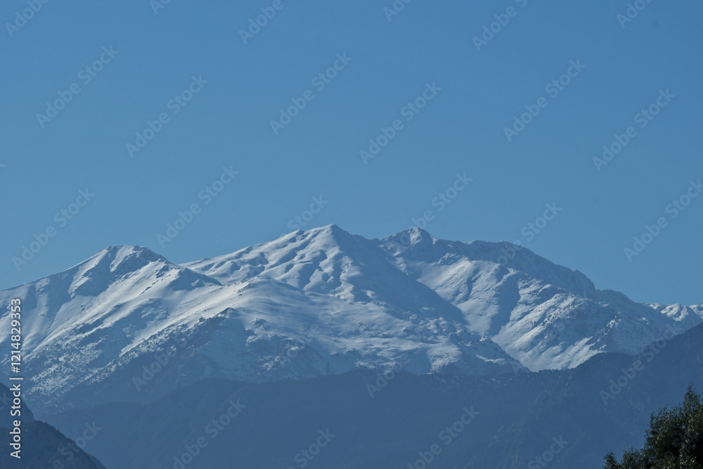 Obraz premium Snowy mountains on a sunny day. Mountain peak against blue sky. Antalya, Türkiye