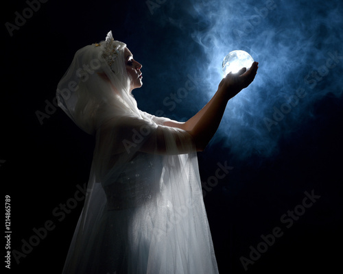 portrait beautiful blonde fantasy maiden faery wearing medieval fairytale ballgown costume, white cape. standing pose isolated dark studio background with mystical  glowing backlight lighting effect photo