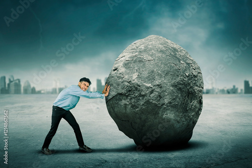 Businessman Pushing a Giant Boulder in a Cityscape Background, Symbolizing Determination and Overcoming Challenges photo