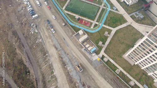 Aerial shot of construction machinery next to a residential complex