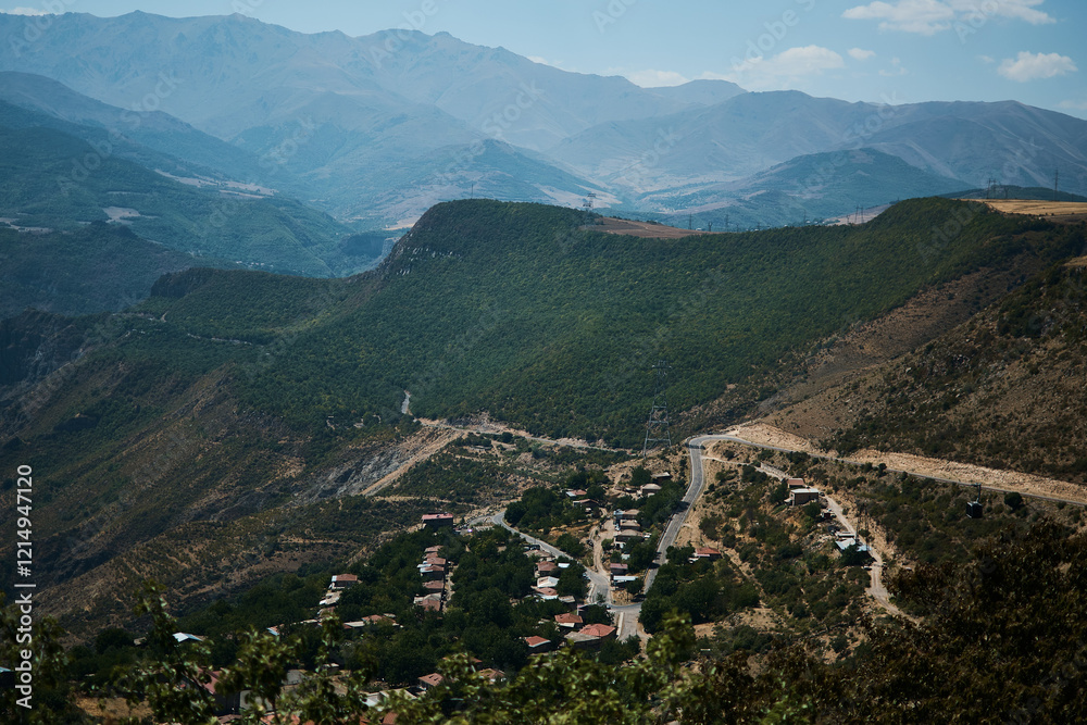 Fototapeta premium a view of the mountain road, city and mountains from the funicular near Tatev Monastery
