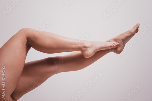 Quadro su tela Cropped photo of attractive young girl posing show perfect legs isolated white r