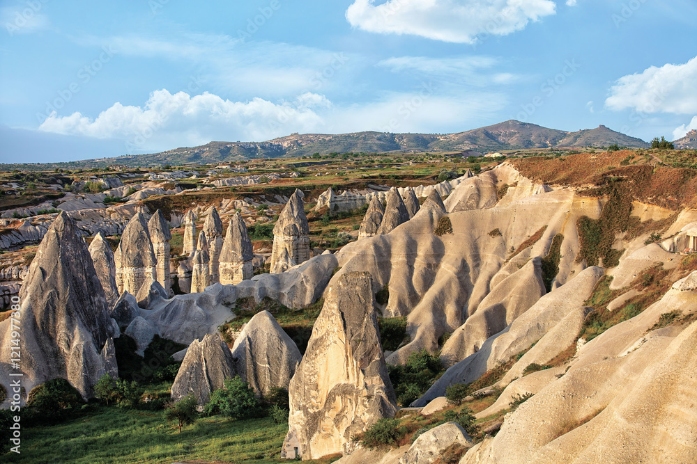 Unique rock formations rise majestically under a clear blue sky in Cappadocia region