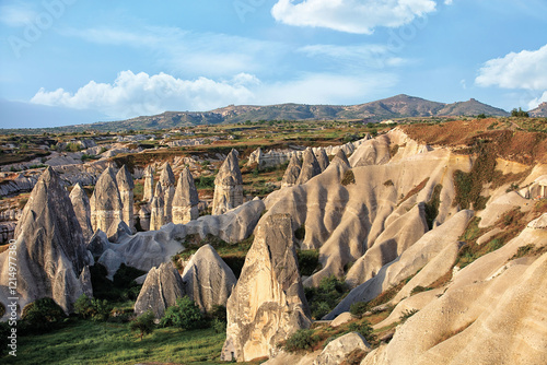 Unique rock formations rise majestically under a clear blue sky in Cappadocia region
