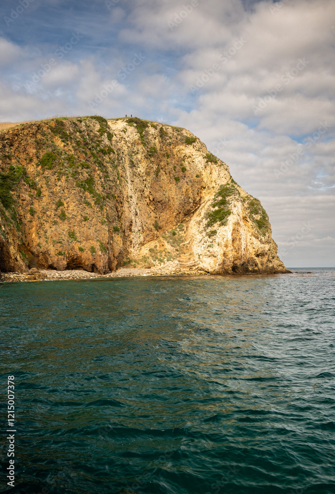 Fototapeta premium Two Hikers Stand On The Cliffs Above Santa Cruz Island