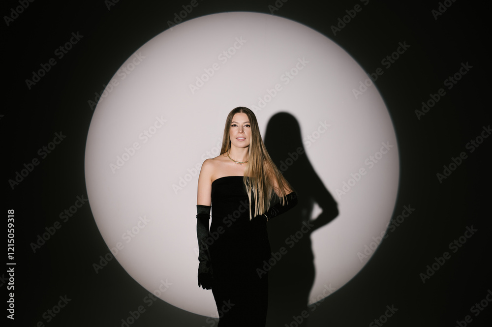 Portrait of a woman in a studio with professional lighting in a smart dress with gloves