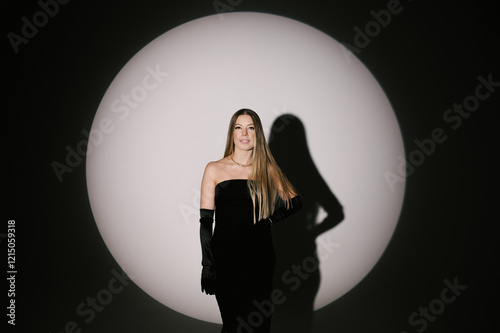 Obraz na płótnie Portrait of a woman in a studio with professional lighting in a smart dress with gloves w salonie