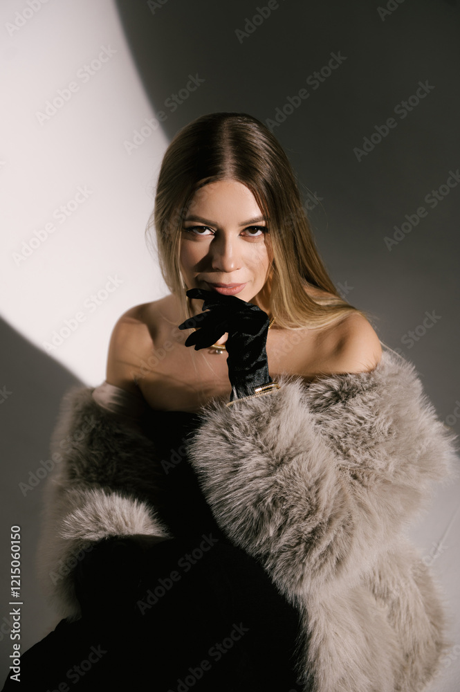 Portrait of a woman in a studio with professional lighting in a smart dress with gloves and a fur coat