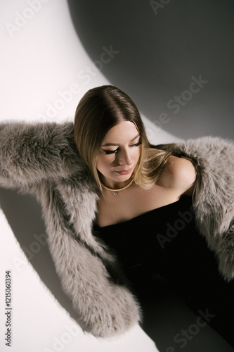 Obraz na płótnie Portrait of a woman in a studio with professional lighting in a smart dress with gloves and a fur coat w salonie