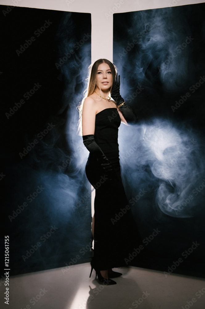 Portrait of a woman in a studio with professional light and smoke in a smart dress with gloves