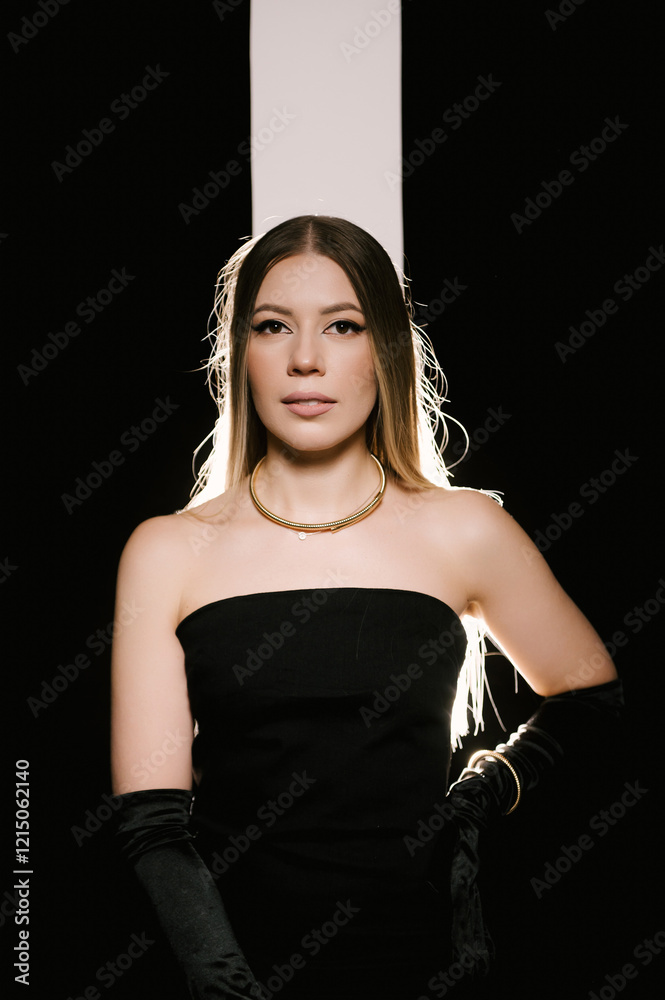 Portrait of a woman in a studio with professional lighting in a smart dress with gloves