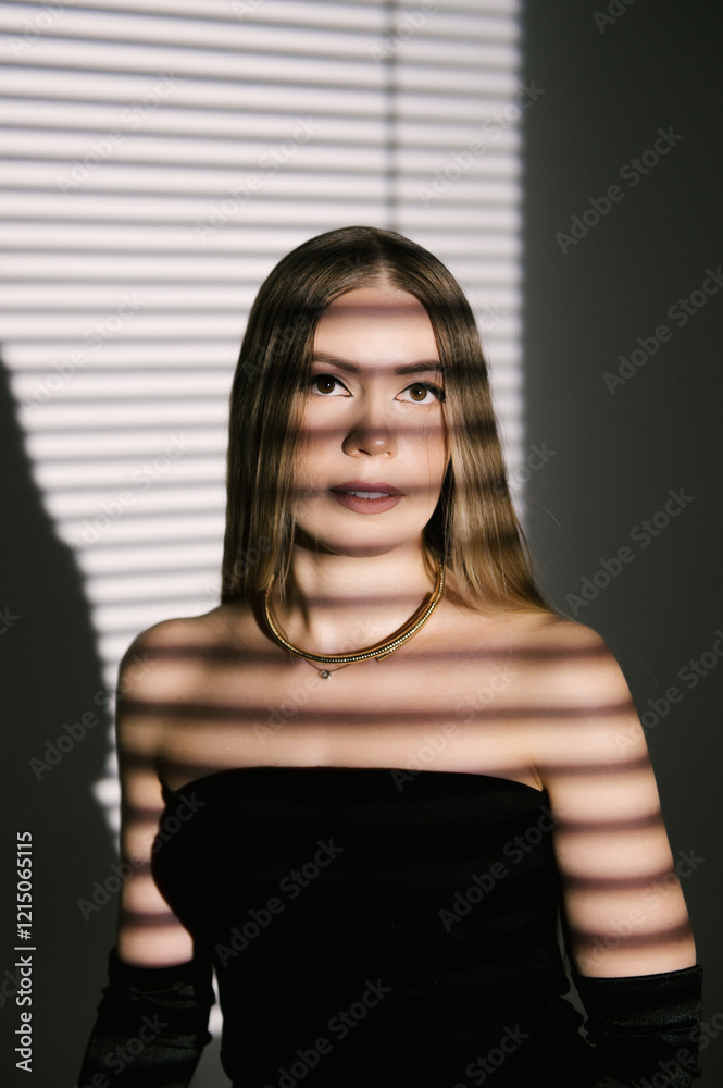 Portrait of a woman in a studio with professional lighting in a smart dress with gloves