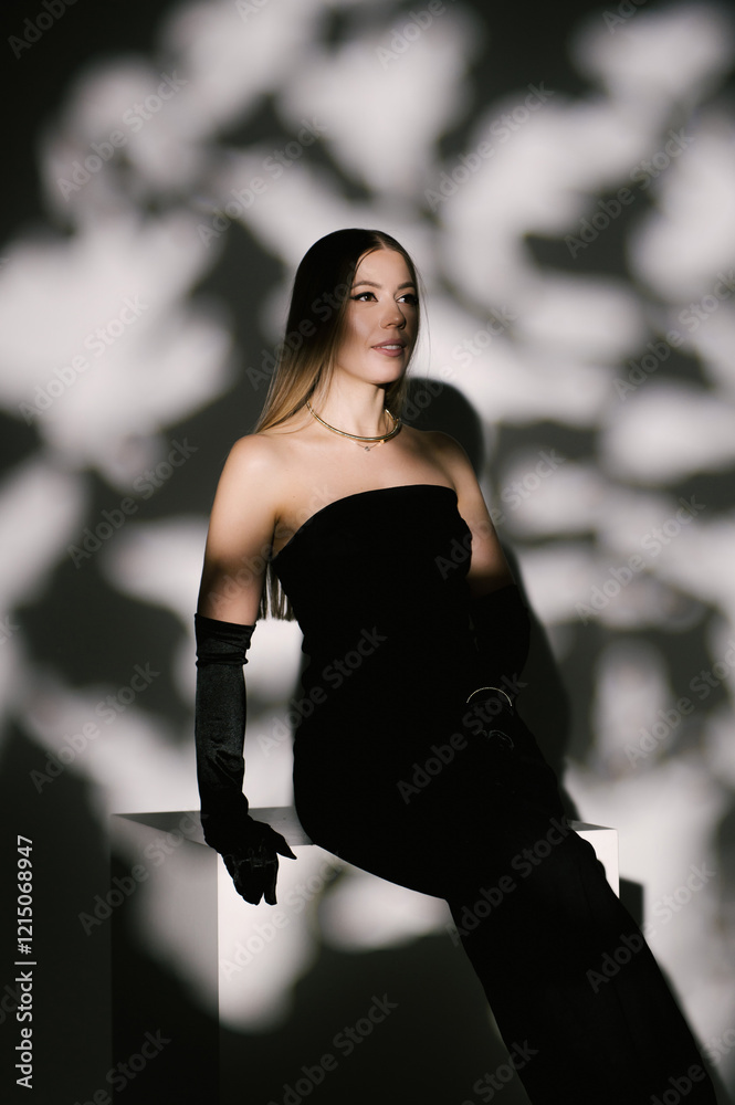 Portrait of a woman in a studio with professional lighting in a smart dress with gloves