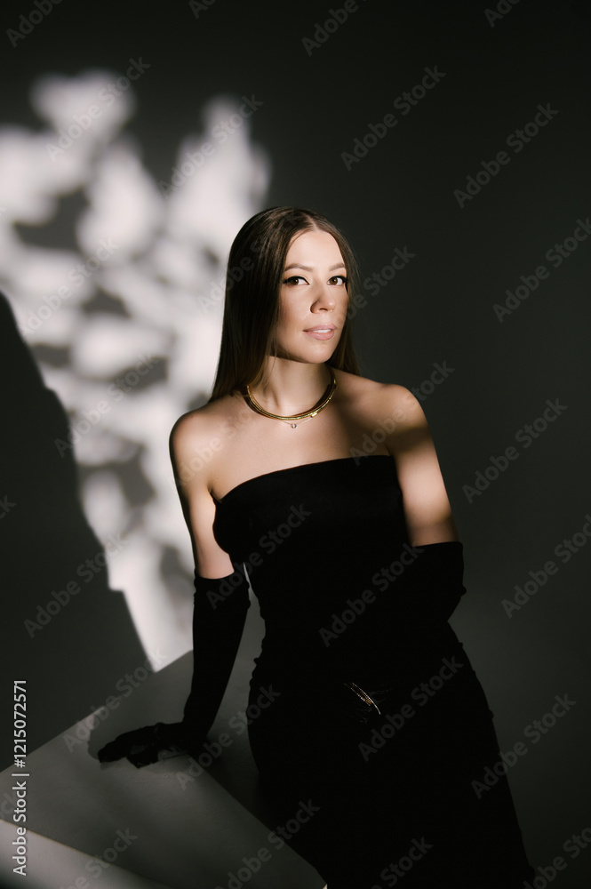 Portrait of a woman in a studio with professional lighting in a smart dress with gloves