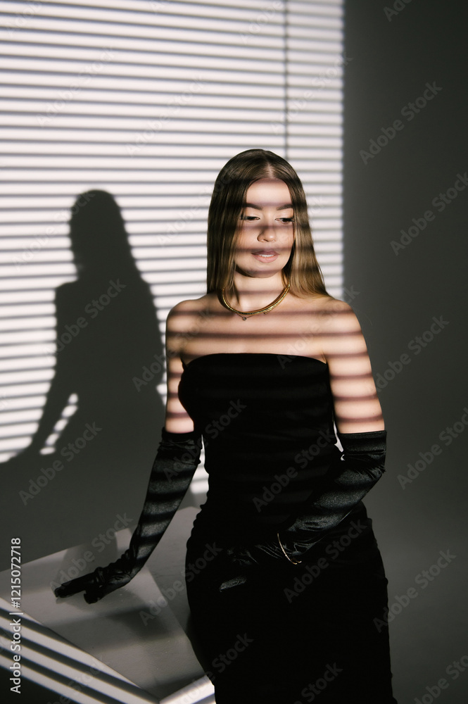 Portrait of a woman in a studio with professional lighting in a smart dress with gloves