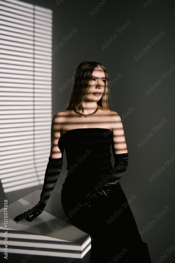 Portrait of a woman in a studio with professional lighting in a smart dress with gloves