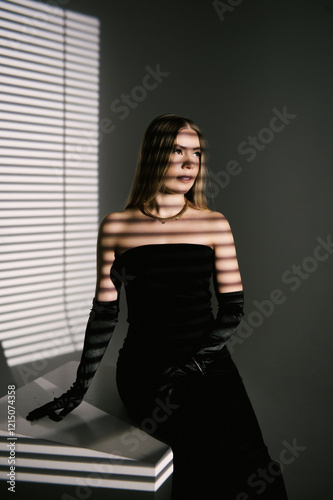 Obraz na płótnie Portrait of a woman in a studio with professional lighting in a smart dress with gloves w salonie
