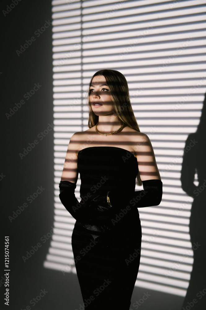 Portrait of a woman in a studio with professional lighting in a smart dress with gloves