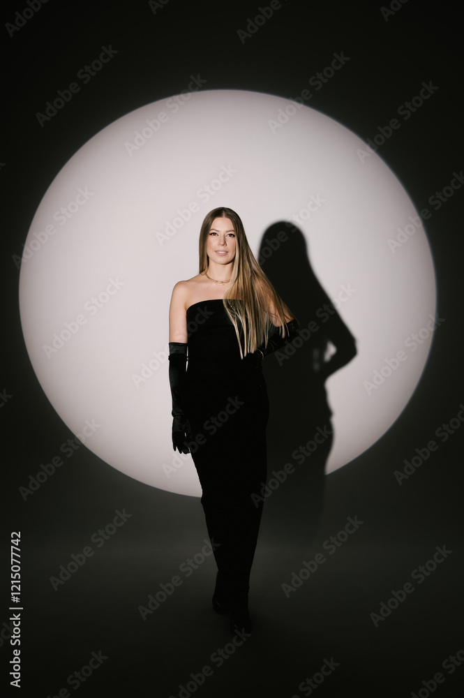 Portrait of a woman in a studio with professional lighting in a smart dress with gloves