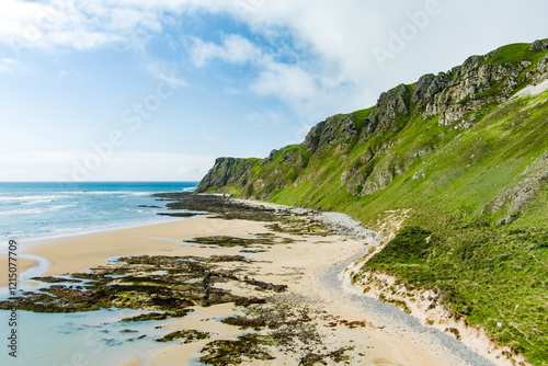 Five Finger Strand, one of the most famous beaches in Inishowen known for its pristine sand and rocky coastline with some of the highest sand dunes in Europe, county Donegal, Ireland. photo