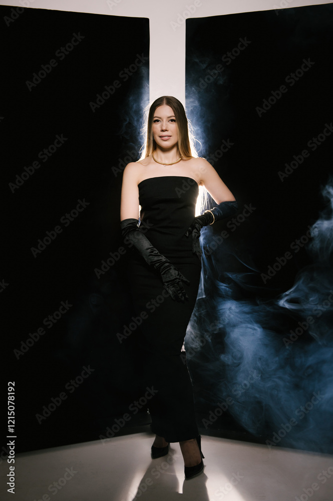 Portrait of a woman in a studio with professional light and smoke in a smart dress with gloves