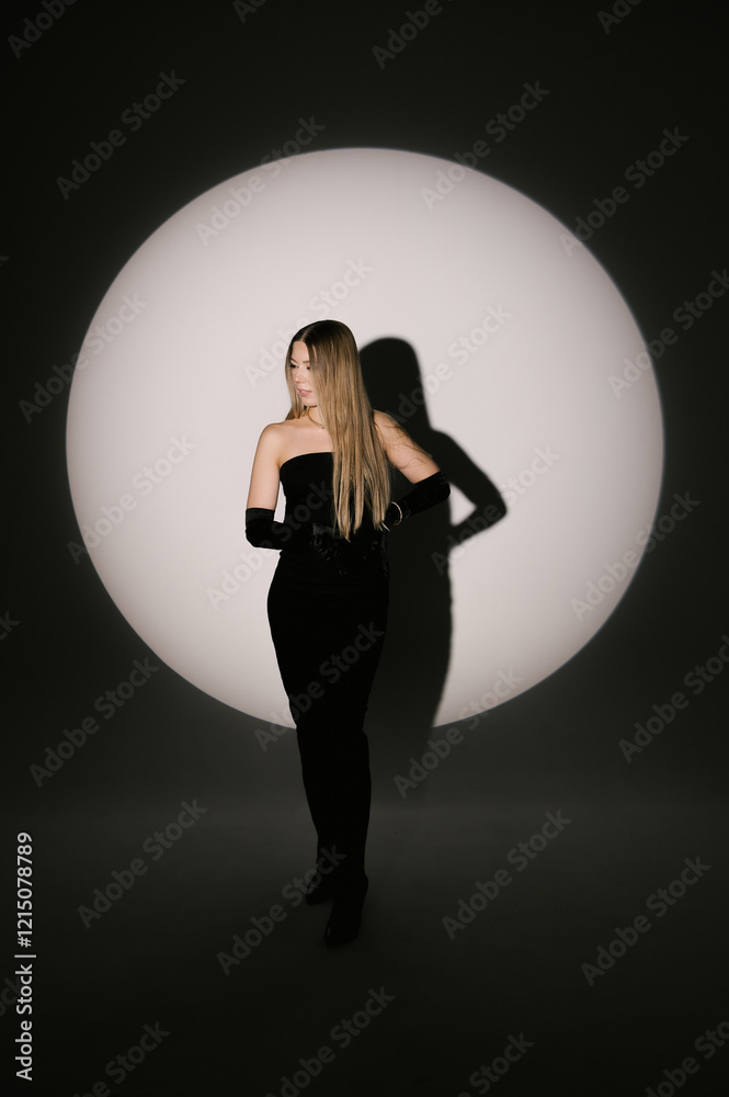 Portrait of a woman in a studio with professional lighting in a smart dress with gloves