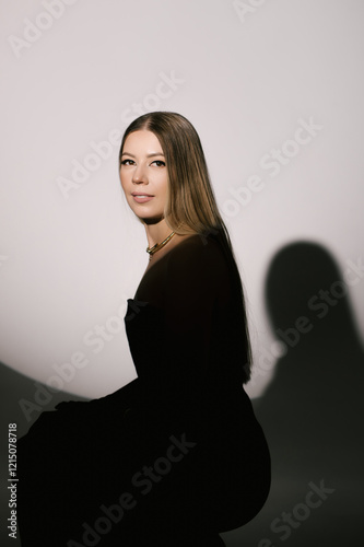 Obraz na płótnie Portrait of a woman in a studio with professional lighting in a smart dress with gloves w salonie
