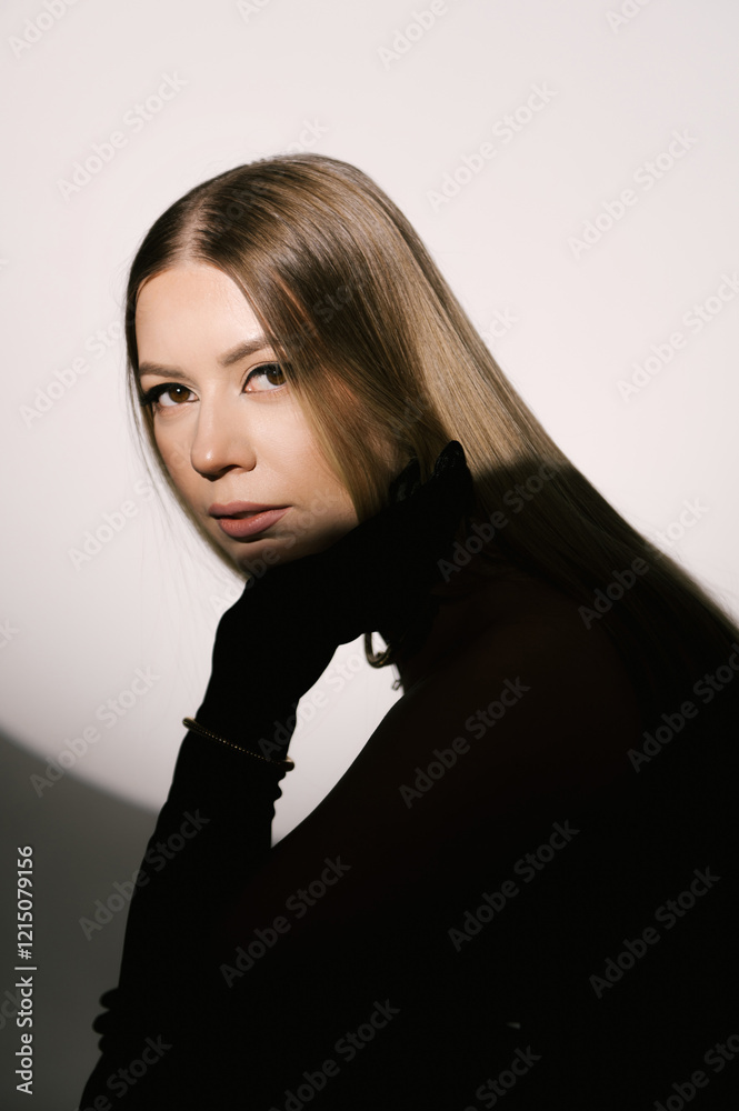 Portrait of a woman in a studio with professional lighting in a smart dress with gloves