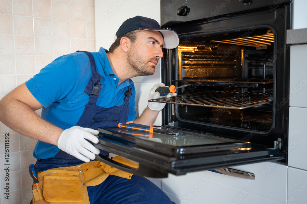 One expert repairman fixing a broken kitchen oven One expert repairman fixing a broken kitchen oven