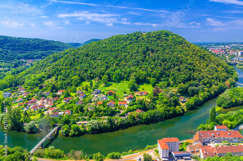 Aerial view of Chaudanne Mount Chaudanne Hill with green forest, residential houses of Mazagran district Besançon city, Doubs river and green hills background, Bourgogne-Franche-Comte region, France photo