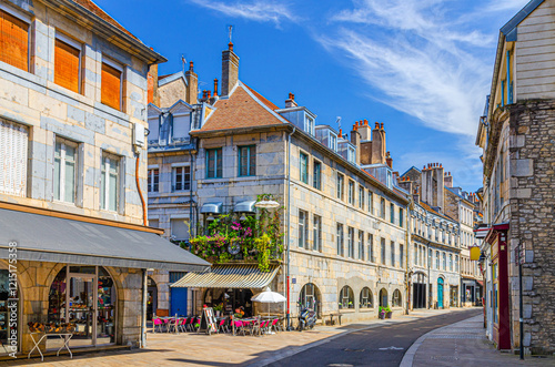 Fototapeta Naklejka Na Ścianę i Meble -  Typical street Rue des Granges in Besancon old town centre ville La boucle, Besançon city historic centre with old houses medieval buildings, street restaurant and cafe in sunny summer day, France
