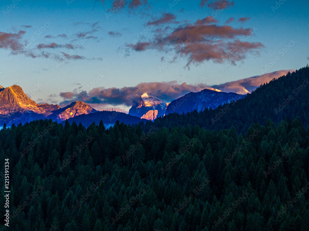 Scenic aerial morning view of misty valleys and forested landscapes in the Dolomites, with Antelao and Cridola peaks in the background. Captured near Danta village, Italy. Hiking in Dolomites.