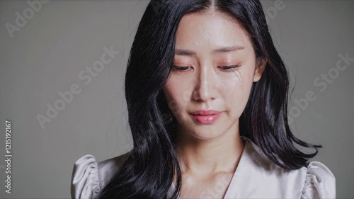 Asian Woman, Contemplative Expression, Grey Studio Backdrop, Digital Overlay