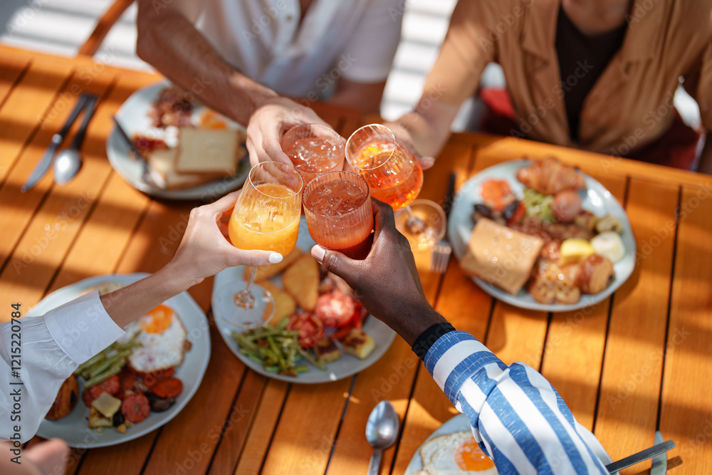 Diverse Friends Toast with Fresh Juice Over Breakfast Diverse Friends Toast with Fresh Juice Over Breakfast