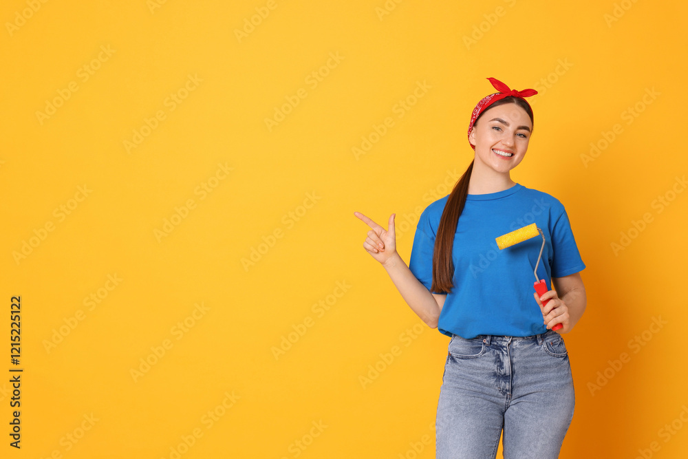Portrait of young decorator with paint roller on orange background, space for text Portrait of young decorator with paint roller on orange background, space for text