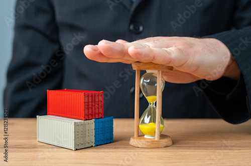 Shipping containers and hourglass supplied by businessman. Delivery times. Acceleration of cargo transportation. Importance of timely delivery, efficient logistics, and faster transportation. photo