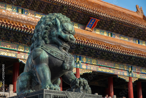 Powerful bronze lion statue guarding the Forbidden City, showcasing intricate imperial craftsmanship, Beijing, China, December 17, 2019