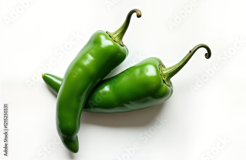 Two fresh green jalapeno peppers displayed against plain white background. Top view highlights vibrant green color, organic texture of peppers. Peppers ripe, whole. Ideal for healthy ingredient for