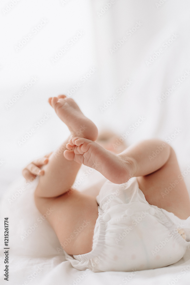 cute little girl lying on the bed. baby girl in white close-up cute little girl lying on the bed. baby girl in white close-up