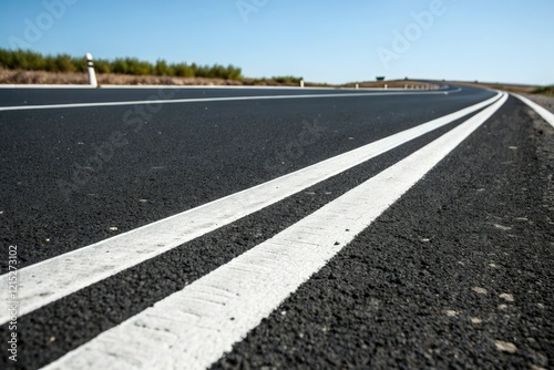 Wallpaper Mural Close-up view of white dividing lines on a black asphalt road, white stripes, road geometry, road markings, lane separator, black asphalt Torontodigital.ca