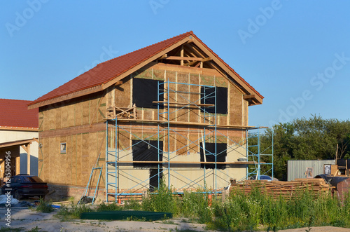 New energy efficient straw house under construction. Using environmentally friendly building materials.