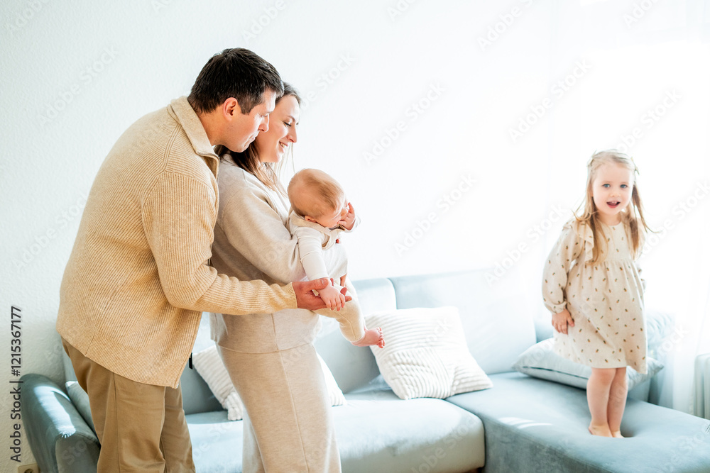 Beautiful happy young family with small children resting at home. Beautiful happy young family with small children resting at home.