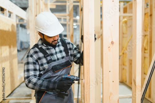 Wallpaper Mural Modern modular house. Indian worker works on the construction of a wooden house Torontodigital.ca