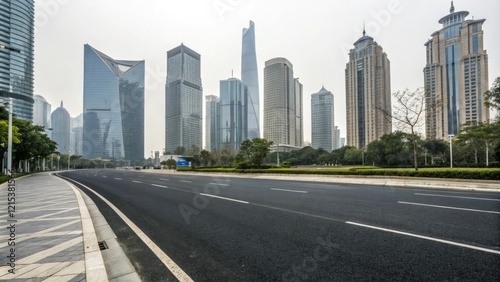 Empty asphalt road passing through the heart of a modern city amidst towering skyscrapers and office buildings, high-rise buildings, urban sprawl