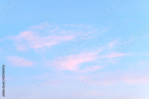 Bright blue sky with light pink clouds