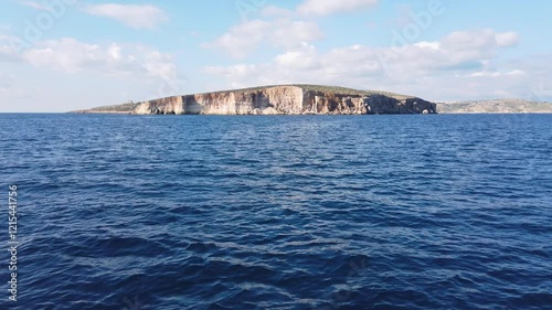 Island of Comino, in the Maltese archipelago, as seen from the sea, with the island of Gozo in the backgrond