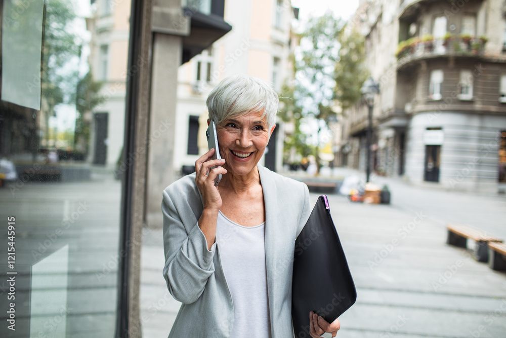 Senior professional businesswoman using smartphone downtown Senior professional businesswoman using smartphone downtown