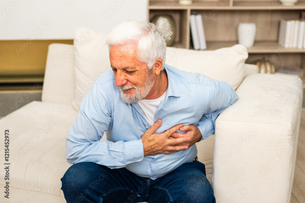 Pain on heart, heart attack. Unhappy middle aged senior man suffering from chest pain heart attack problems with health at home. Mature old senior grandfather touching chest experiencing infarction Pain on heart, heart attack. Unhappy middle aged senior man suffering from chest pain heart attack problems with health at home. Mature old senior grandfather touching chest experiencing infarction