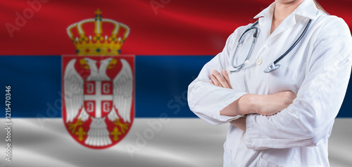 Foto Doctor with crossed arms on Serbia flag
