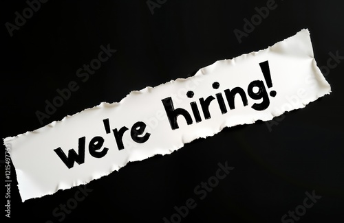 Torn white paper announces hiring on black background. Business concept image. Recruitment hiring announcement. Opportunity for job seekers. Company looking for new talents. Recruiting now. Ideal for photo